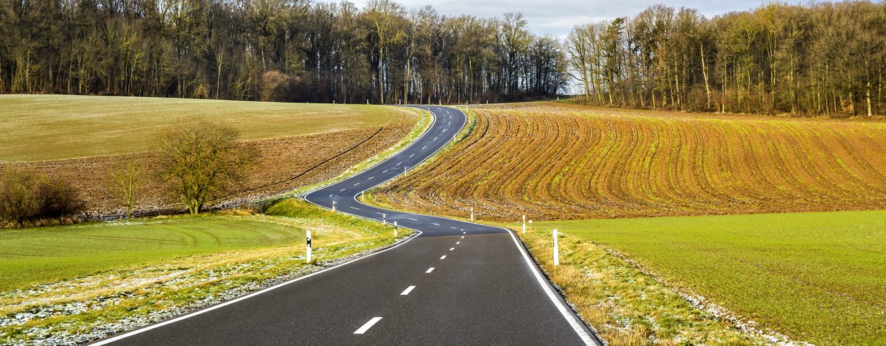 Winding Road In Field During Long Distance Towing Trip