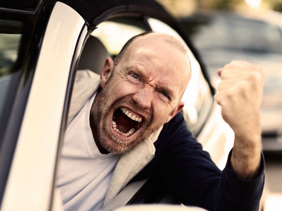 Man Sticking Fist Out Of Window While Driving Aggressively
