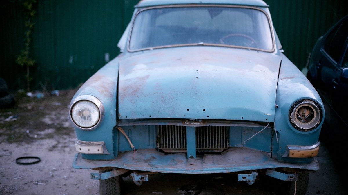 old retro car parked in a car junk shop