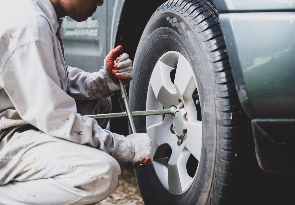 man fixing a flat tire