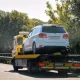 flatbed tow truck carrying a car