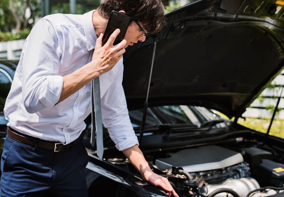 man calling for help because his car transmission is dead